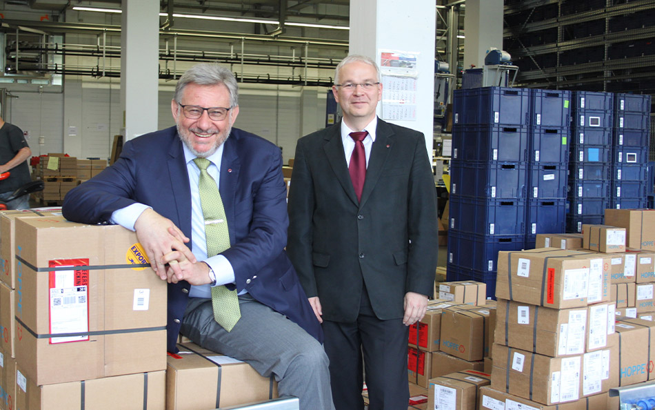 Wolf Hoppe’s Face (on The Left in The Picture) is Beaming with Joy over The Successful Strategy Project. Next to him is Thomas Hahn, Plant Manager of The Newly Established HOPPE Group Assembly and Logistics Centre. Photo by: Silke Koppers