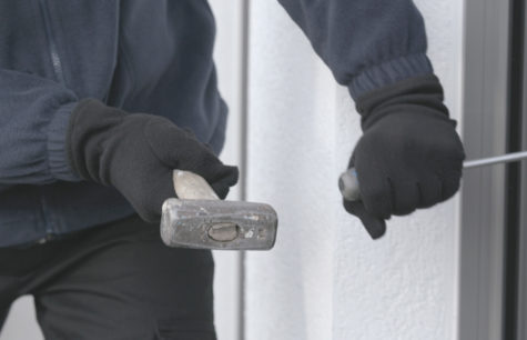 A burglar trying to reach the handle by piercing the glass seal or drilling the frame